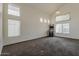 Bright and spacious living room with high ceilings and large windows, featuring neutral-toned carpet at 1079 E Jasper Dr, Gilbert, AZ 85296