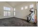 Bright living area with large windows and carpet flooring, creating a welcoming and open space at 1079 E Jasper Dr, Gilbert, AZ 85296