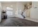 Open-concept living area with staircase, enhanced by bright lighting and high ceilings, creating an airy atmosphere at 1079 E Jasper Dr, Gilbert, AZ 85296