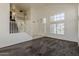 Spacious living area with high ceilings and large windows, seamlessly connecting to the entrance and staircase at 1079 E Jasper Dr, Gilbert, AZ 85296
