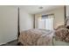 Comfortable main bedroom with a decorative window valance, natural lighting and 4 poster bed at 1079 E Jasper Dr, Gilbert, AZ 85296