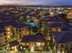 Aerial view of the community at dusk showcasing lush landscaping and warm lighting at 11640 N Tatum Blvd # 1095, Phoenix, AZ 85028