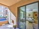 Cozy outdoor balcony with sliding glass doors leading into the stylishly furnished living room at 11640 N Tatum Blvd # 1095, Phoenix, AZ 85028