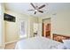 Bedroom featuring a ceiling fan, natural light, and access to the backyard with ensuite bathroom at 11640 N Tatum Blvd # 1095, Phoenix, AZ 85028
