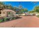 The Faderra Community Entrance features brick paving, lush landscaping, and a gated entry, promising a secure environment at 11640 N Tatum Blvd # 1095, Phoenix, AZ 85028