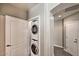 Hallway view of a stacked washer and dryer in a closet at 11640 N Tatum Blvd # 1095, Phoenix, AZ 85028