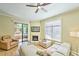 Bright living room with fireplace, wood floors, and sliding glass doors that lead to an outdoor patio at 11640 N Tatum Blvd # 1095, Phoenix, AZ 85028