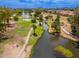 Scenic aerial view featuring a community lake with meandering paths, palm trees, and verdant landscaping for outdoor enjoyment at 1217 N Miller Rd # 23, Scottsdale, AZ 85257