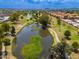 Beautiful aerial view of a community lake, lined with walking paths and mature trees, creating a peaceful environment at 1217 N Miller Rd # 23, Scottsdale, AZ 85257