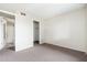 Bright, carpeted bedroom with entrances to a bathroom and walk-in closet at 1217 N Miller Rd # 23, Scottsdale, AZ 85257