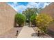 A pathway flanked by colorful foliage leads to a gate, adding to the home's curb appeal at 1217 N Miller Rd # 23, Scottsdale, AZ 85257