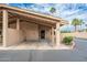 A tan single-story home features a two-car carport, desert landscaping and an inviting entrance at 1217 N Miller Rd # 23, Scottsdale, AZ 85257