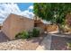 A tan single-story home with desert landscaping and a gated front patio offers privacy at 1217 N Miller Rd # 23, Scottsdale, AZ 85257