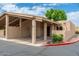 A tan single-story home features a two-car carport, desert landscaping and an inviting entrance at 1217 N Miller Rd # 23, Scottsdale, AZ 85257