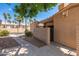 A tan single-story home features a pergola entrance, desert landscaping and a gated front patio at 1217 N Miller Rd # 23, Scottsdale, AZ 85257