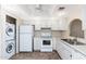 Efficient kitchen layout features white appliances and is conveniently adjoined by a laundry area at 1217 N Miller Rd # 23, Scottsdale, AZ 85257