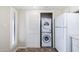 Stackable washer and dryer in laundry area. The space is next to a window, and a full-sized refrigerator at 1217 N Miller Rd # 23, Scottsdale, AZ 85257