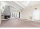 Spacious living room with fireplace, French doors and exposed beam ceiling at 1217 N Miller Rd # 23, Scottsdale, AZ 85257