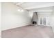 The spacious living room features a fireplace, light walls, and carpeted floors at 1217 N Miller Rd # 23, Scottsdale, AZ 85257