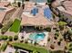 Aerial view of home showcasing the roof's solar panels and backyard with pool, spa, and outdoor kitchen at 12976 W Plum Rd, Peoria, AZ 85383