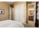 Cozy bedroom with closet and adjoining bathroom at 12976 W Plum Rd, Peoria, AZ 85383