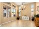 Bright dining room with large windows, chandelier lighting, and neutral decor at 12976 W Plum Rd, Peoria, AZ 85383
