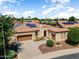 Charming single-Gathering home featuring a tile roof, solar panels, two-car garage, and manicured landscaping at 12976 W Plum Rd, Peoria, AZ 85383