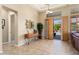 Welcoming foyer featuring tile flooring, a decorative mirror, and a view of the outdoor pool at 12976 W Plum Rd, Peoria, AZ 85383