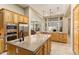 Open kitchen featuring a center island with seating and stainless steel appliances at 12976 W Plum Rd, Peoria, AZ 85383