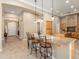 Spacious kitchen with a large center island, bar seating, pendant lighting, and custom cabinetry at 12976 W Plum Rd, Peoria, AZ 85383