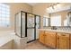 Bright bathroom with a framed shower, tile floors, soaking tub, and double sink vanity at 12976 W Plum Rd, Peoria, AZ 85383