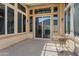 Covered patio with brick pavers, large sliding glass doors, and an outdoor seating area at 12976 W Plum Rd, Peoria, AZ 85383