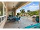 Covered patio with outdoor dining area, ceiling fan, and view of the pool and landscaped backyard at 12976 W Plum Rd, Peoria, AZ 85383