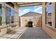 Inviting outdoor patio with brick pavers, fireplace, and shaded seating area at 12976 W Plum Rd, Peoria, AZ 85383