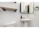 Modern bathroom featuring a pedestal sink, shelving and white fixtures at 1322 S Owl Dr, Gilbert, AZ 85296