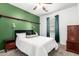 Cozy bedroom featuring plush carpet, a queen-size bed, and warm, inviting lighting at 1322 S Owl Dr, Gilbert, AZ 85296
