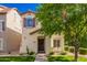 Charming two-story home features a well-manicured lawn, a front porch bench, and desert landscaping at 1322 S Owl Dr, Gilbert, AZ 85296