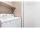 Functional laundry area with white washing machine and convenient shelving at 1322 S Owl Dr, Gilbert, AZ 85296
