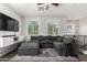 Upstairs living room with a comfortable sectional sofa, patterned rug, and abundant natural light at 1322 S Owl Dr, Gilbert, AZ 85296