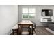 Dining table is next to large windows and TV at 1322 S Owl Dr, Gilbert, AZ 85296