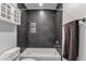 Nicely remodeled bathroom featuring dark tile and a shower-tub combo at 13636 N Hamilton Dr # 101, Fountain Hills, AZ 85268