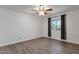 Bright bedroom with wood-look floors, a ceiling fan, and a window with neutral-colored curtains at 13636 N Hamilton Dr # 101, Fountain Hills, AZ 85268