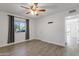 Bedroom features wood-look floors, a ceiling fan, and easy access to the adjoining spaces at 13636 N Hamilton Dr # 101, Fountain Hills, AZ 85268