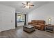 Comfortable living room with window, wood-look floors, brown sofa, and stylish coffee table at 13636 N Hamilton Dr # 101, Fountain Hills, AZ 85268