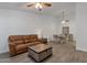 Spacious living room with comfortable sofa, dining area, wood floors, and neutral decor at 13636 N Hamilton Dr # 101, Fountain Hills, AZ 85268