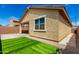 Rear exterior view of house, showcasing the stucco siding, window details, and artificial grass at 14355 W Valentine St, Surprise, AZ 85379