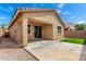 Exterior house featuring an outdoor patio, artificial grass, and desert landscaping for a serene environment at 14355 W Valentine St, Surprise, AZ 85379
