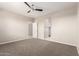 Spacious carpeted bedroom with open entry to the en-suite bathroom and large closet at 14355 W Valentine St, Surprise, AZ 85379