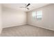 Bright bedroom featuring a ceiling fan, plush carpet, and a window providing natural light at 14355 W Valentine St, Surprise, AZ 85379
