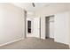 Carpeted bedroom with an open doorway to a bathroom and a built-in closet at 14355 W Valentine St, Surprise, AZ 85379
